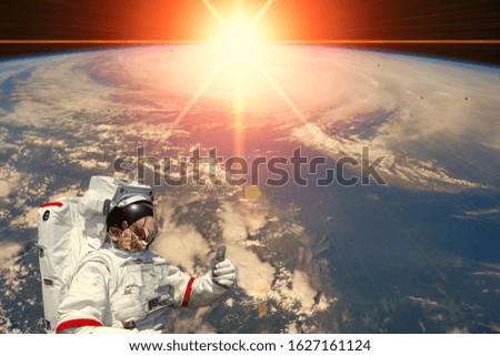 Astronaut and sunrise. The elements of this image furnished by NASA.
