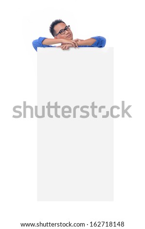 Young man holding blank billboard