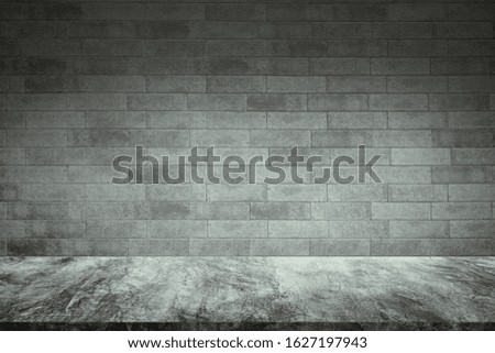 Empty concrete table with old bricks wall background. For display or montage your products.