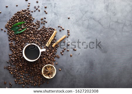 Bag of coffee. Coffee beans roasted on the table. Coffee beans with leaves for cooking.