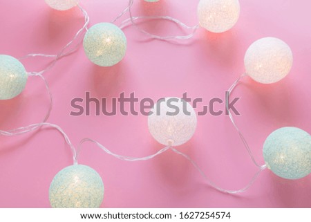 Blue and white cotton balls led lights on a pink background festive party backdrop