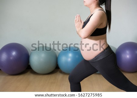 healthy pregnant woman doing yoga in gym. Working out, yoga and fitness, pregnancy concept