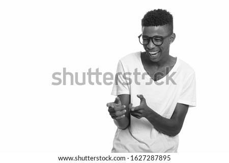 Young happy African man laughing and pointing fingers