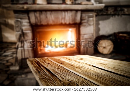 Table background of free space and blurred interior with fireplace 