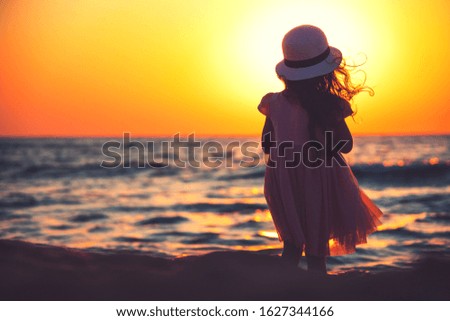 Little girl playing on the beach.