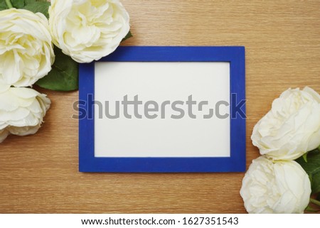 space photo frame on wooden background