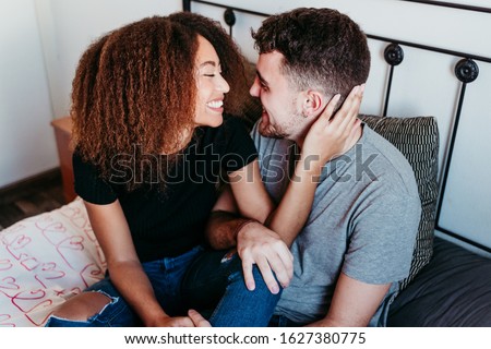 happy couple in love at home. Afro american woman and caucasian man. ethnic love concept Royalty-Free Stock Photo #1627380775