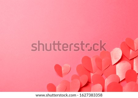 Cut out of red paper hearts on pink background. Good Valentines day, Womans day, love, romantic or wedding composition with empty space for custom text for banner, congratulation, advertising
