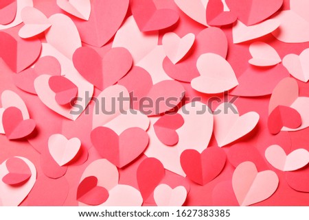 Bunch of cut out of pink and red paper hearts on red background. Cute Valentines day, Womans day, love, romantic or wedding card, banner, invitation, sale, offer, ad background