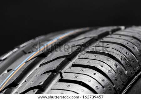 Car tires close-up wheel profile structure on black background