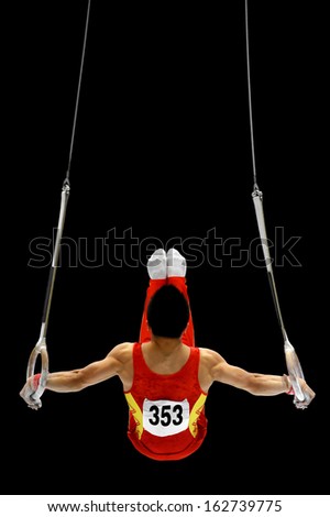 Back view with a gymnast performing on the rings apparatus