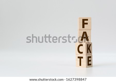 Fact or Fake concept, Wooden cube change the word, April fools day Royalty-Free Stock Photo #1627398847