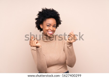 African american woman over isolated background making money gesture
