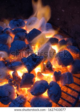 Open flames on a barbecue with glowing coals