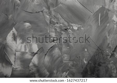 Textured plastered background with a variety of arbitrary stains. Gray.