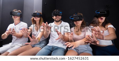 Young people having fun with a new technology vr headset goggles 