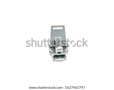 Zipper slider on a white background. Place for text. Free place. Macro photo.