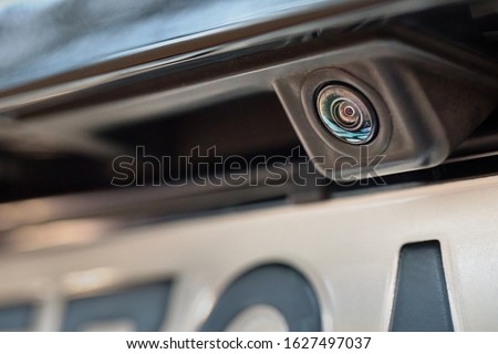 Luxury car rear view camera close up for parking assistance. Concept of safety car driving while parking process. Assist device equipment in modern cars Royalty-Free Stock Photo #1627497037