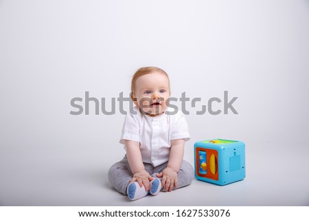 toddler boy playing with educational toy isolated on white background