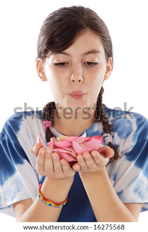 Cute girl blowing petals over white background
