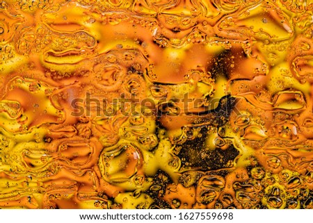 Yellow Abstract background. Drops of water and oil. 