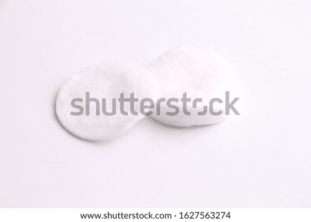 Cleansing cotton discs in colorful background