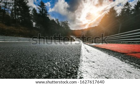 Race Car / motorcycle racetrack after rain on a cloudy day Royalty-Free Stock Photo #1627617640