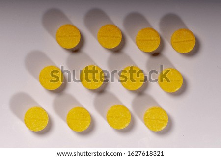 Yellow food supplement drugs are isolated against a white background, macro photography