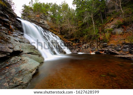 Laverty Falls in Fundy National Park in New Brunswick in Autumn Season with Fall foliage. Beautiful Waterfalls in Autumn Fall Foliage Landscape with orange maple leaves, Canada