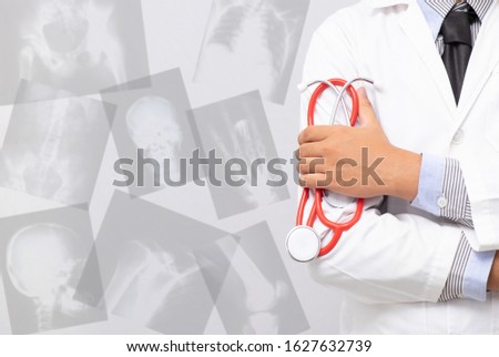 doctor holding stethoscope with x ray film background