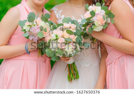 closeup of wedding bouquets in hands of bride and bridesmaids.