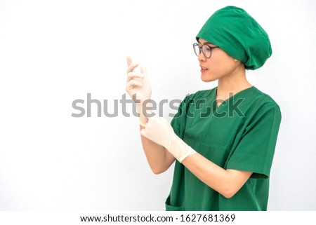 Portrait of Asian nurse raised her hands while wearing rubber gloves in hospital operation room. Ready for work in surgery operating.