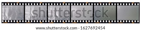 long 35 mm film strip isolated on white background with empty or blank cells for your social media content, just blend in your photos here, vintage photoplaceholder, dia positive material. Royalty-Free Stock Photo #1627692454