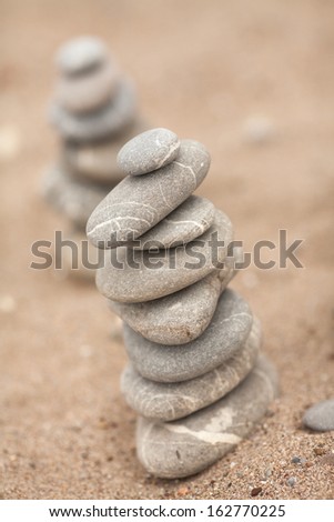 Zen stones pyramid on sand beach, meditation, concentration, relaxation, harmony, balance, ocean in pure simplicity. Japanese stone pyramid. finding solutions with zen mindset. zen stones jy garden