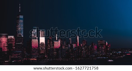 Amazing panorama view on New York City skyline and Downtown Manhattan from Jersey City during night. Banner image