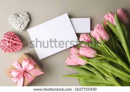 Tulips, gift, hearts and empty places on grey background, space for text