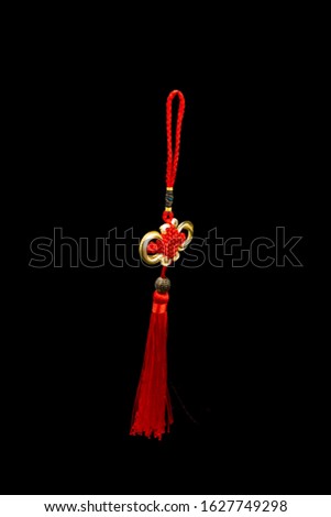 Chinese knotting with red braid on a black background