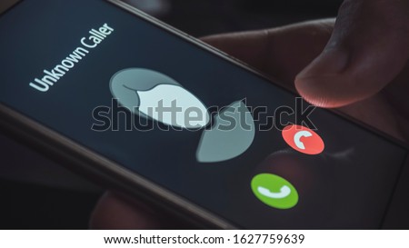 Unknown caller. A man holds a phone in his hand and thinks to end the call. Incoming from an unknown number at night. Incognito or anonymous Royalty-Free Stock Photo #1627759639