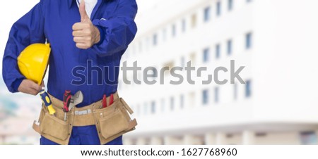 builder with helmet and tools doing ok symbol