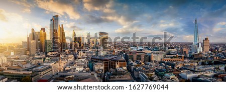 The iconic skyline of London, United Kingdom, during sunset time with golden light and reflections in the modern skyscrapers