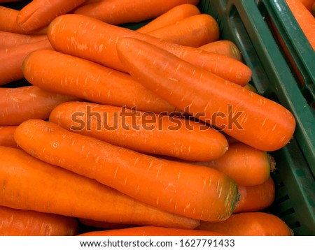 carrots in green plastic tray at market