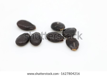 Watermelon seeds isolated on white background. Flat lay. Black seed Pattern. Food concept. Royalty-Free Stock Photo #1627804216
