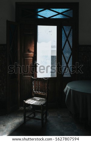 chair alone in an old and desolate dining room