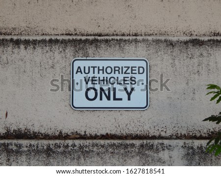 Authorized Vehicles Only signage on an old textured wall 