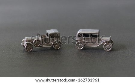 chrome metal key chains in the form of a vintage car on a dark background
