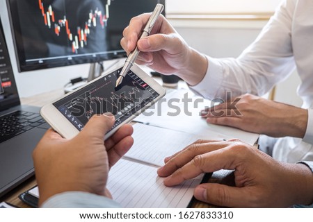 Business team on meeting to planning investment trading project and strategy of deal on a stock exchange with partner, financial and accounting concept, collaborative teamwork analyze data. Royalty-Free Stock Photo #1627833310