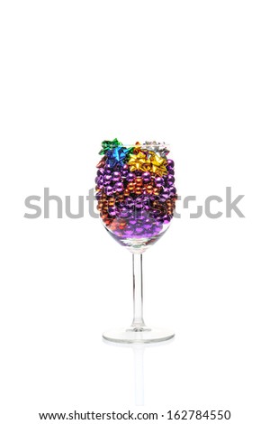 Christmas balls in a vine glass isolated on white.