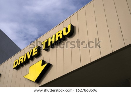 A large sign directs motorists to the drive thru window in this building.