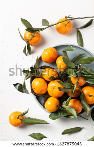 Fresh oranges with leaves on a white background. Top view