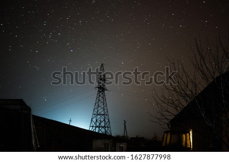 
Power tower silhouette. Night and starry sky with a power tower.